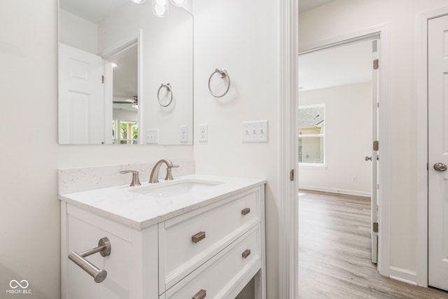 bathroom featuring ceiling fan, wood-type flooring, and vanity