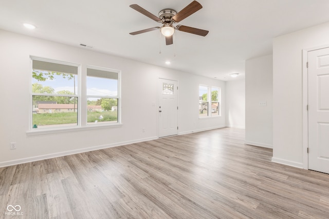 spare room featuring ceiling fan and light hardwood / wood-style floors