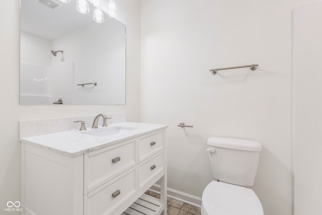 bathroom with toilet, vanity, tile patterned flooring, and a shower