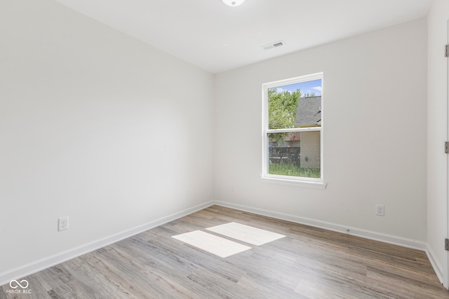 spare room with light hardwood / wood-style flooring and a healthy amount of sunlight