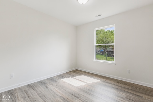 spare room with hardwood / wood-style floors