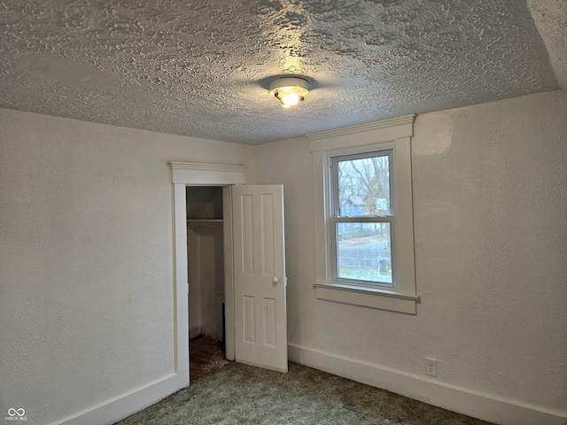 unfurnished bedroom featuring a closet, carpet, and a textured ceiling