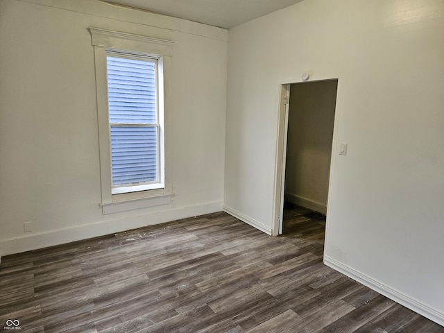 spare room featuring dark wood-type flooring