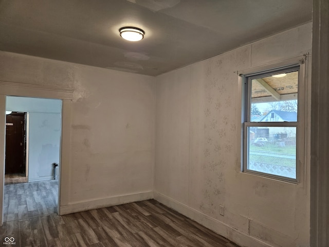 spare room with dark hardwood / wood-style flooring