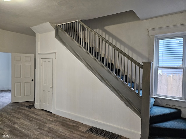 stairs featuring hardwood / wood-style flooring