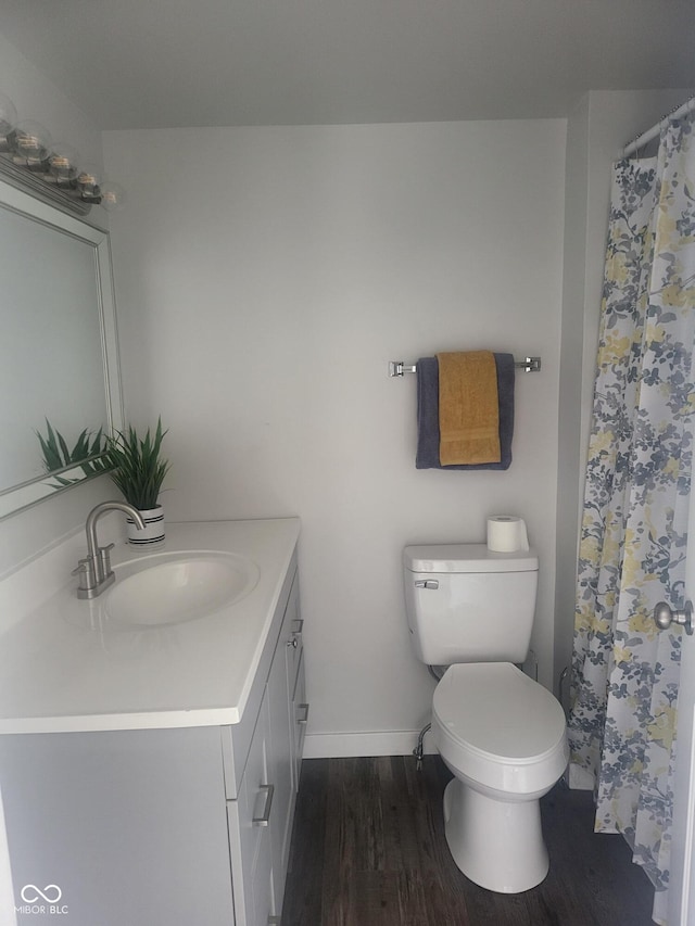 bathroom featuring hardwood / wood-style floors, vanity, and toilet