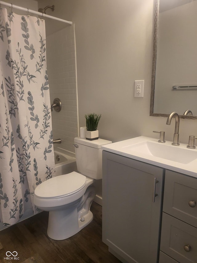 full bathroom with hardwood / wood-style flooring, vanity, toilet, and shower / tub combo with curtain