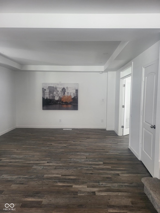 spare room with dark wood-type flooring