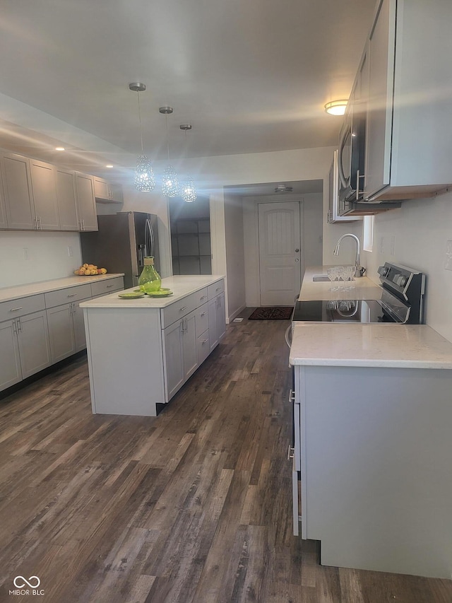 kitchen featuring stainless steel refrigerator with ice dispenser, dark hardwood / wood-style floors, gray cabinets, and pendant lighting