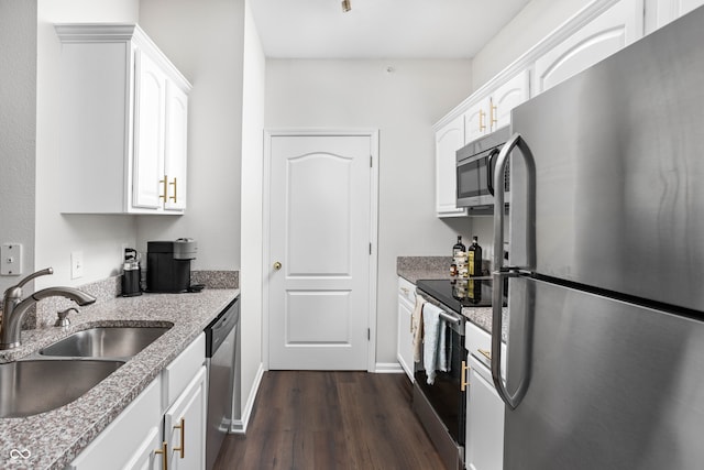 kitchen featuring dark hardwood / wood-style flooring, white cabinetry, sink, and appliances with stainless steel finishes