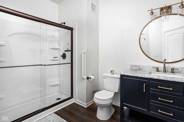 bathroom with vanity, wood-type flooring, an enclosed shower, and toilet