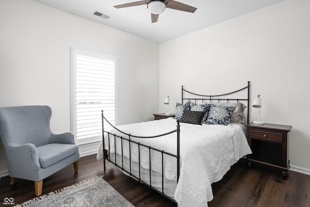 bedroom with multiple windows, ceiling fan, and dark wood-type flooring