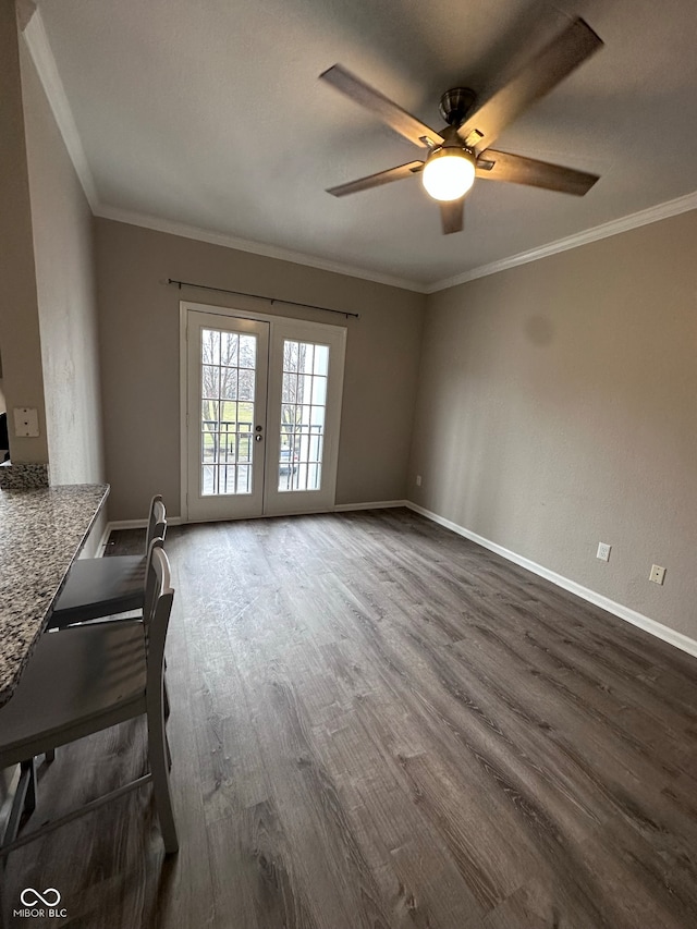 unfurnished living room featuring crown molding, ceiling fan, french doors, and dark wood-type flooring