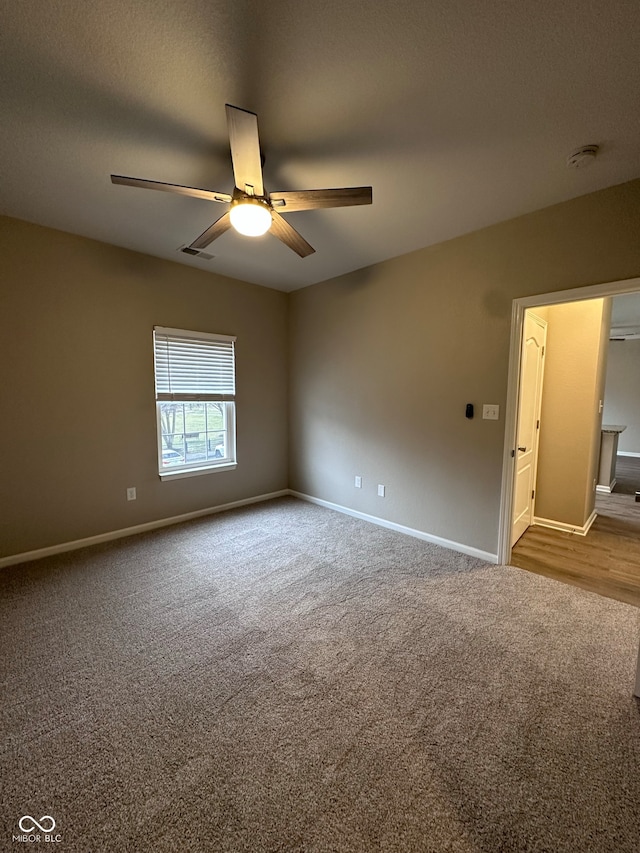 empty room featuring carpet flooring, a textured ceiling, and ceiling fan