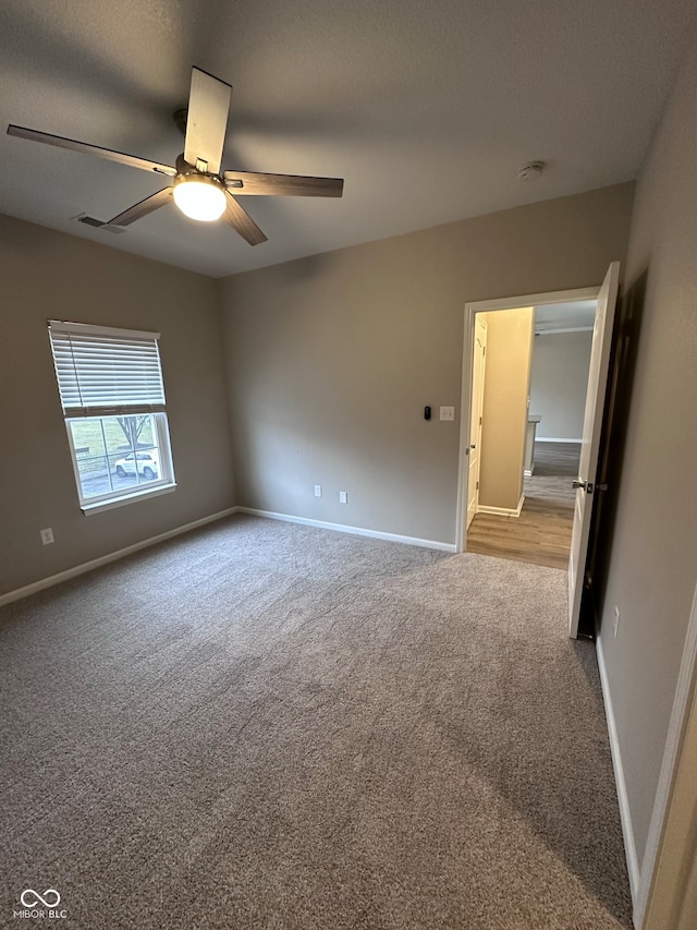 spare room with light carpet and ceiling fan