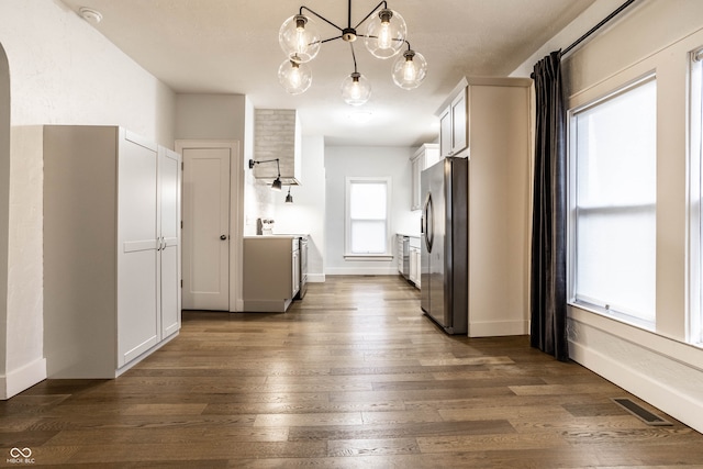 kitchen with white cabinets, dark hardwood / wood-style flooring, and hanging light fixtures