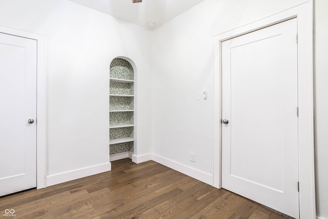 unfurnished room featuring dark wood-type flooring