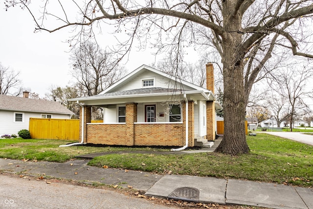 bungalow-style home featuring a porch and a front yard