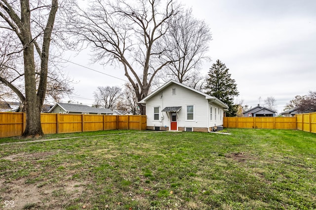 rear view of property with a lawn