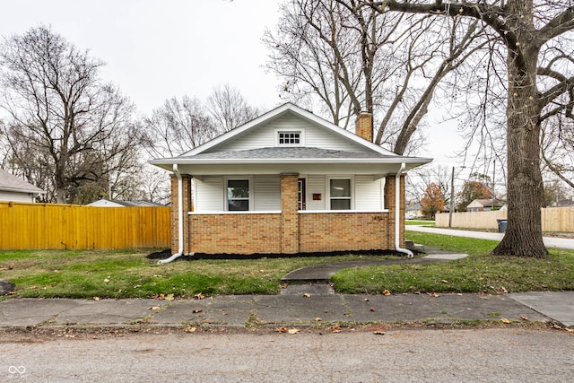 bungalow-style house featuring a front yard