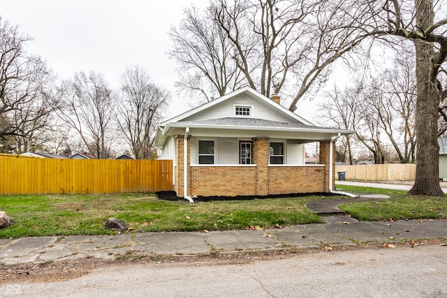 bungalow-style house with a front lawn