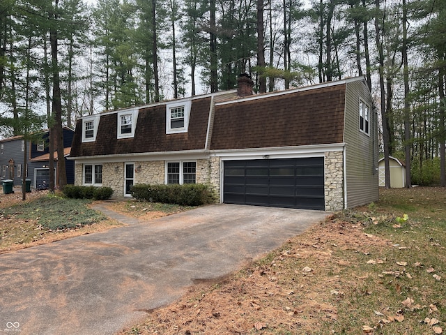 view of front of house featuring a garage and a storage unit