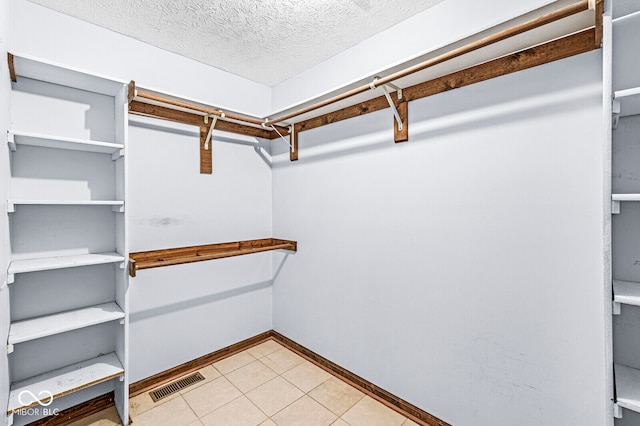 walk in closet featuring light tile patterned floors