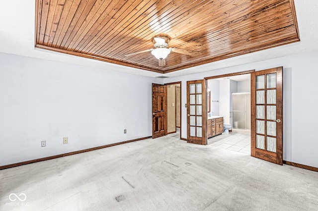 unfurnished room featuring light colored carpet, wood ceiling, a tray ceiling, and french doors