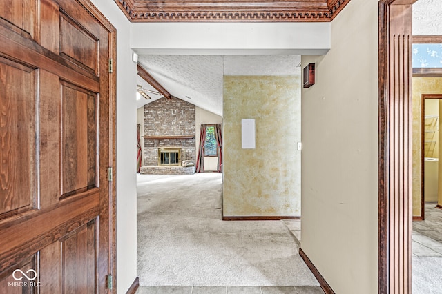 corridor featuring lofted ceiling with beams, light colored carpet, and a textured ceiling