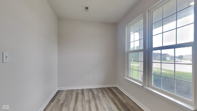 empty room with hardwood / wood-style floors