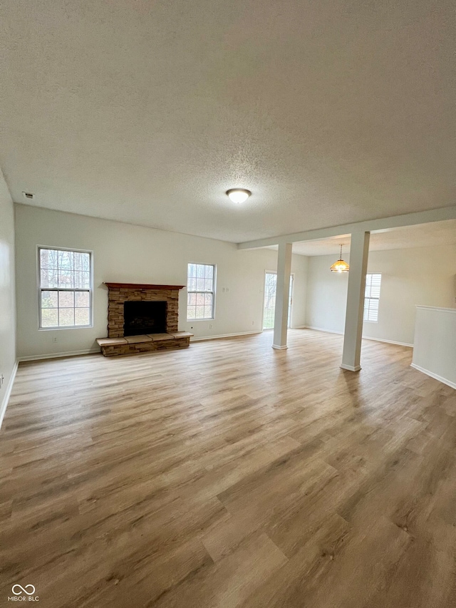 unfurnished living room with a textured ceiling and hardwood / wood-style flooring