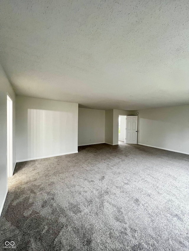 interior space featuring a textured ceiling and carpet floors