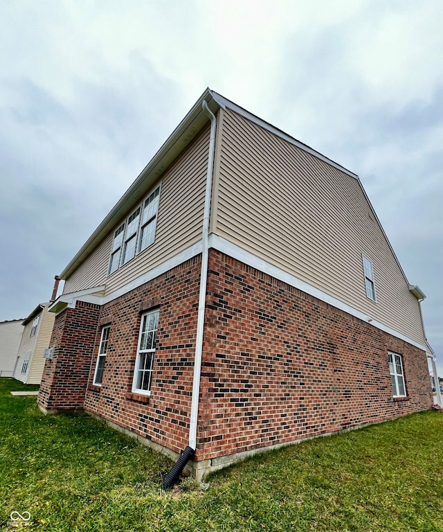 view of side of home with a lawn