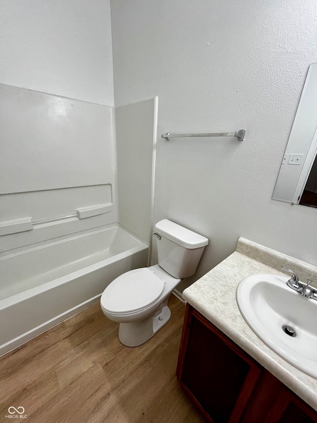 full bathroom with vanity, toilet, wood-type flooring, and bathtub / shower combination