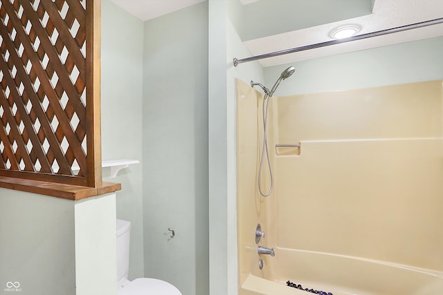 bathroom with shower / bath combination and toilet