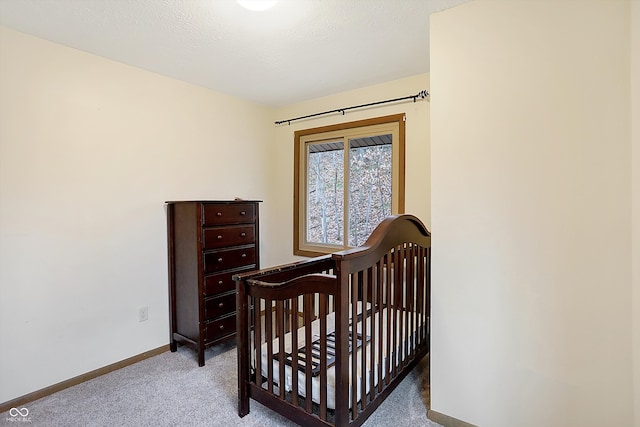 bedroom featuring a textured ceiling and a nursery area