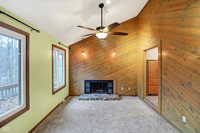 unfurnished living room with wood walls and a wealth of natural light