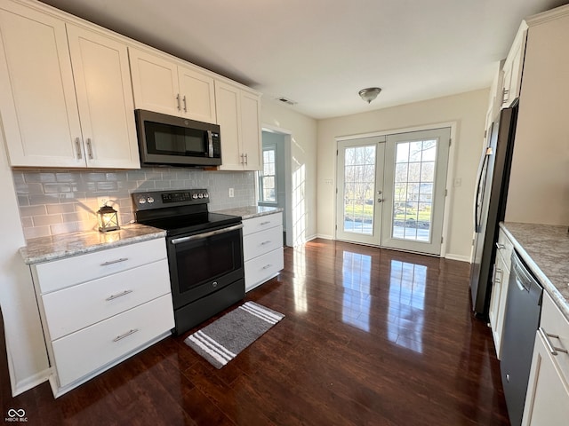 kitchen with french doors, stainless steel appliances, dark hardwood / wood-style flooring, decorative backsplash, and white cabinets