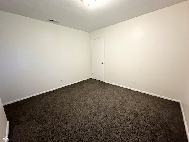 empty room with dark carpet