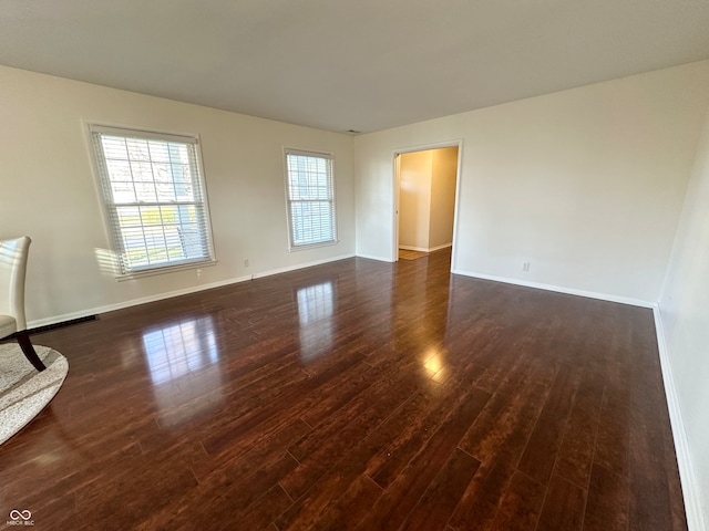 spare room with dark hardwood / wood-style flooring