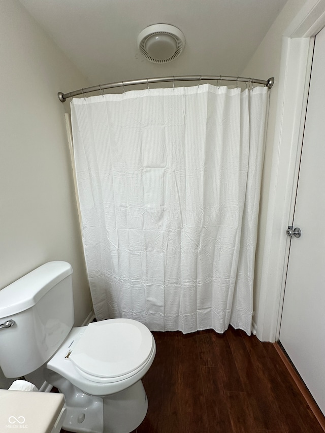 bathroom with wood-type flooring and toilet