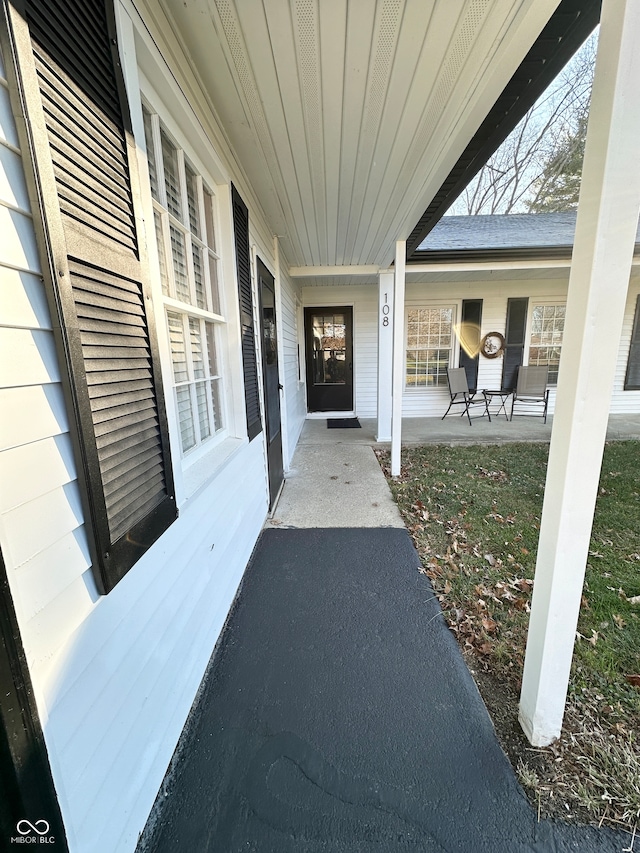 doorway to property featuring covered porch