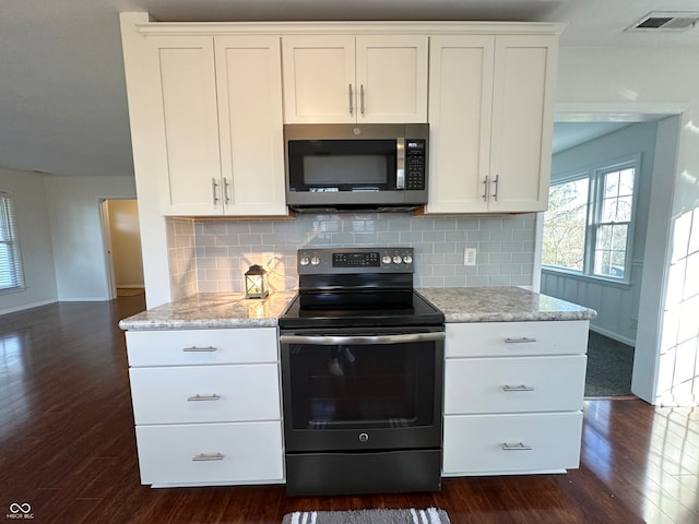 kitchen with white cabinets, dark hardwood / wood-style flooring, and stainless steel appliances