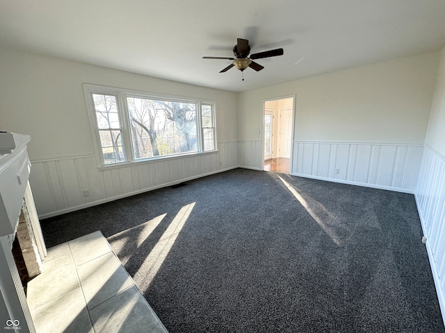 empty room featuring carpet flooring and ceiling fan