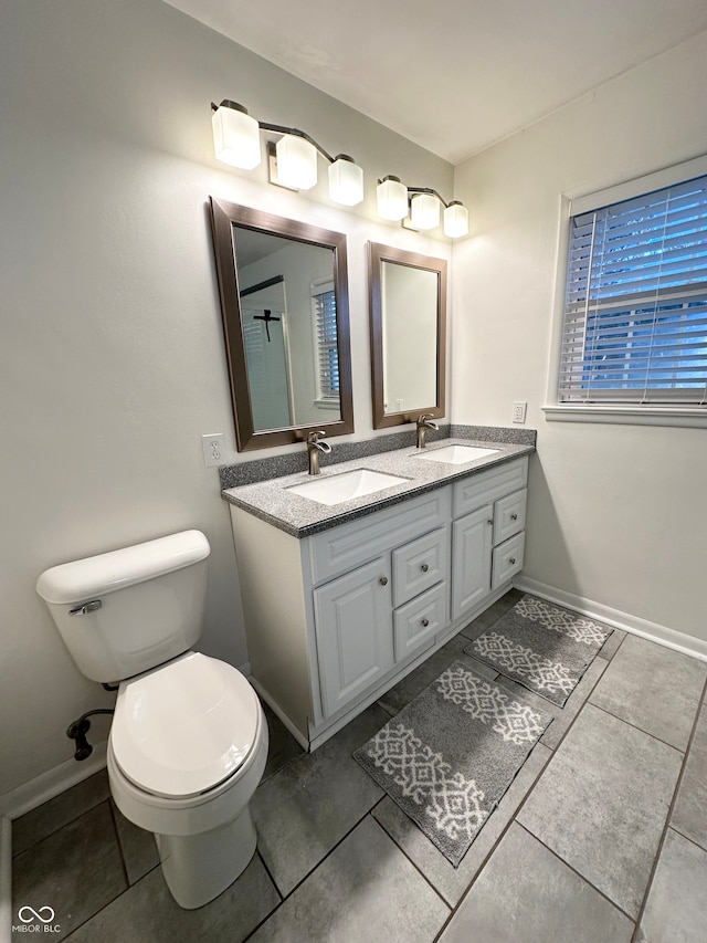 bathroom featuring tile patterned flooring, vanity, and toilet