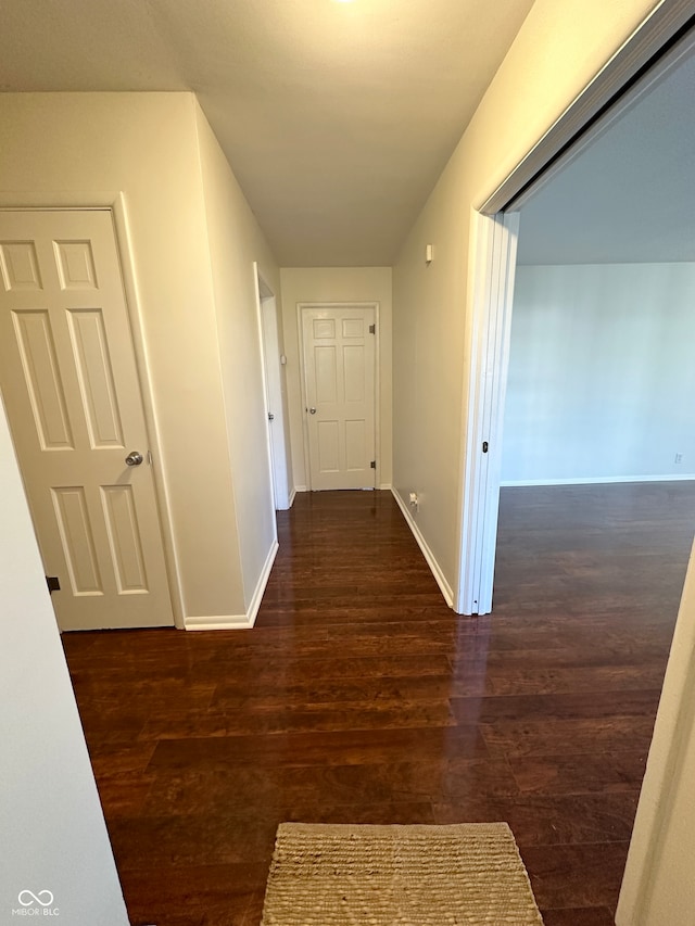 hallway with dark hardwood / wood-style floors