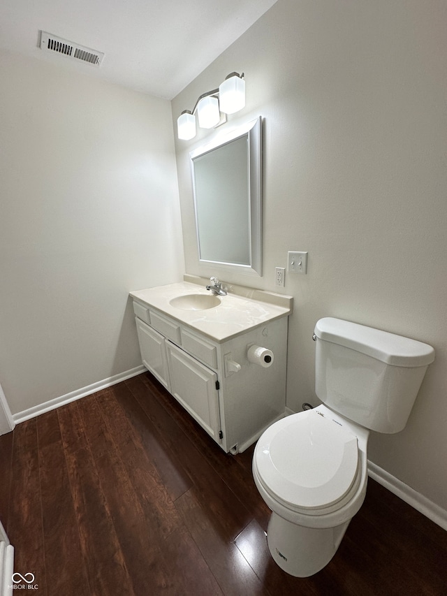 bathroom featuring hardwood / wood-style flooring, vanity, and toilet