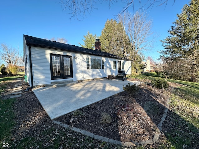 rear view of house featuring a patio area and french doors