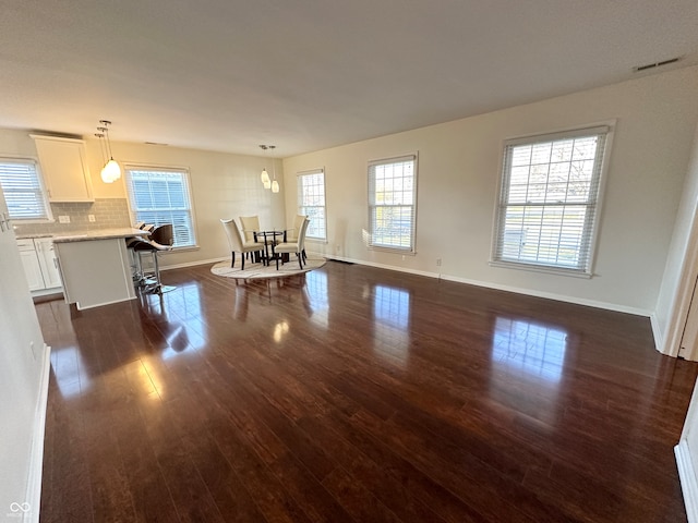 living room featuring dark hardwood / wood-style floors and a wealth of natural light