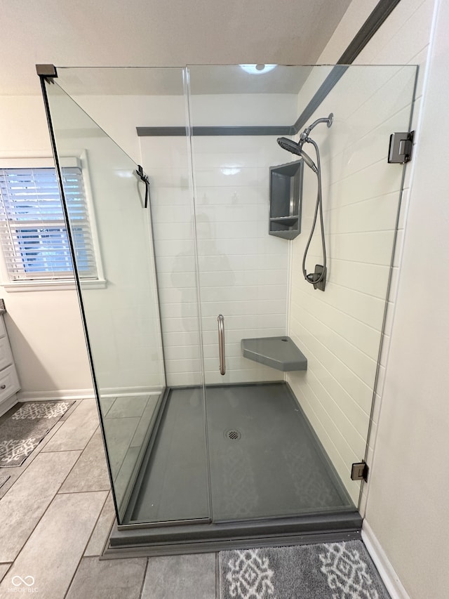 bathroom featuring tile patterned floors and a shower with door